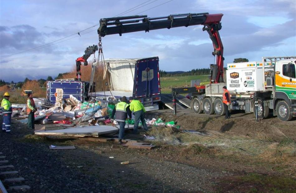 The cleanup continues after a truck crash near Hampden yesterday. Photo by David Bruce.