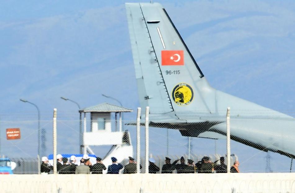The coffin of the pilot is carried to a Turkish Air Force cargo aircraft on the tarmac of the...