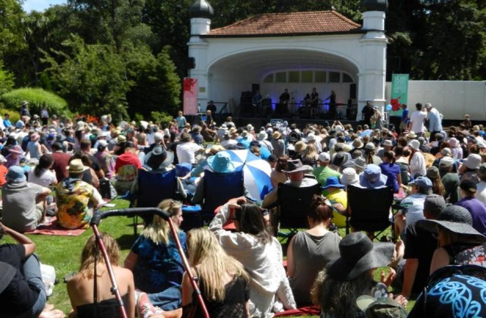 The crowd soak up the sun and the sound of Dunedin music legends the Chills in the lower Botanic...