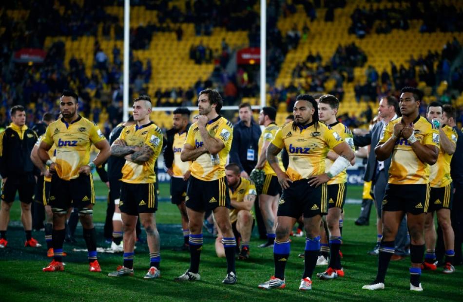 The Hurricanes look dejected as they wait for the trophy presentation following the Super Rugby...