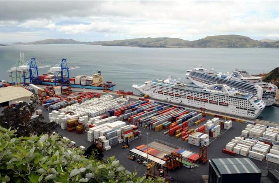 The <i> Oluf Maersk </i> (left)  begins unloading on Saturday morning, with the cruise ships <i>...