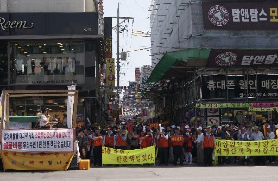 The Jeon family and their neighbours hold one of many protests in the hope local or national...