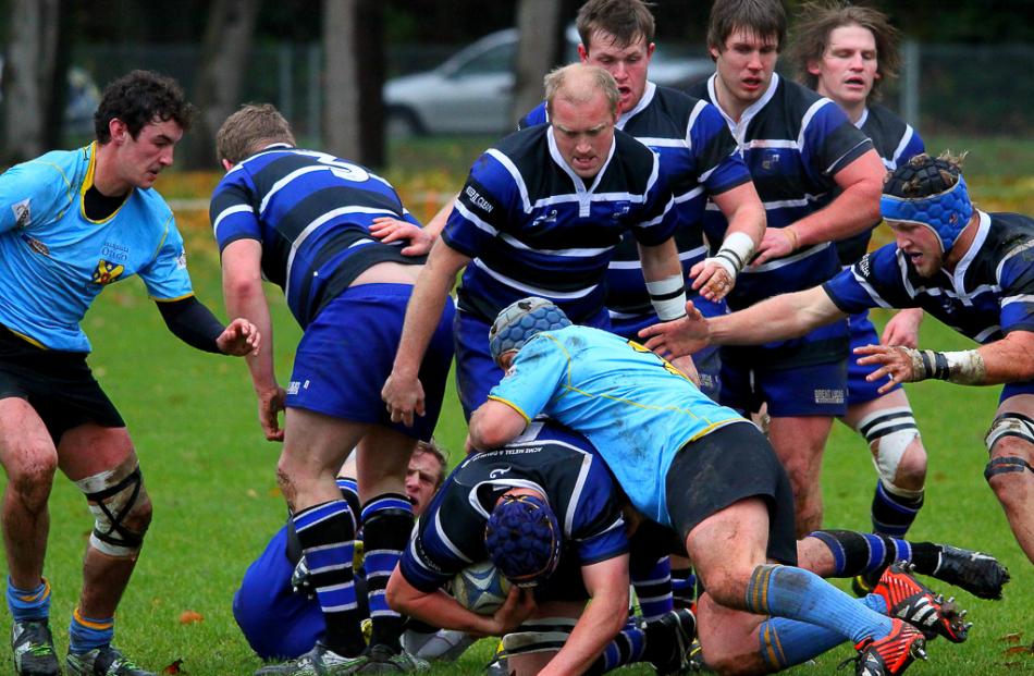 The Kaikorai team drive through the fringes of a ruck early in the match against University A....