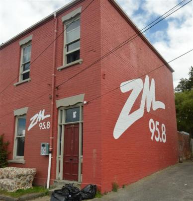 The logos on this Castle St, Dunedin, flat are to be removed. Photo by Peter McIntosh.