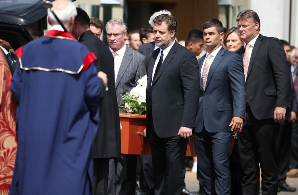 The pall bearers carrying Martin Crowe's casket after today's funeral service. Photo: Getty Images