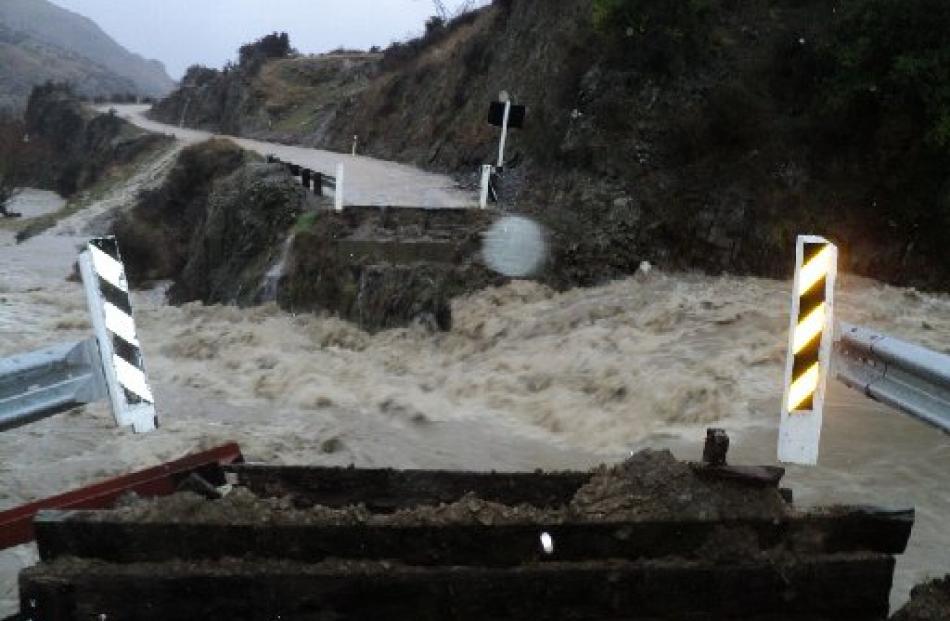 The raging floodwaters of the north branch of the Maerewhenua River take out a bridge on Danseys...