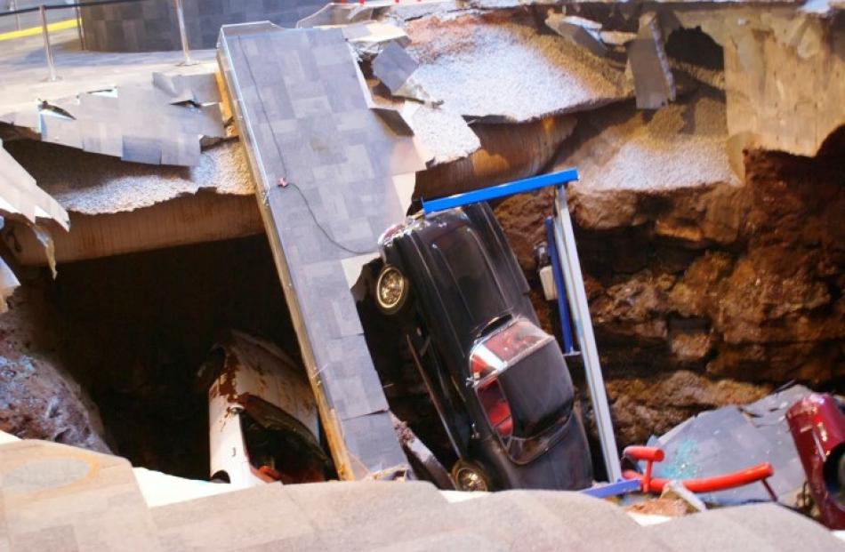 The sinkhole swallowed eight cars, including the one-millionth Corvette built in 1992. Photos:...