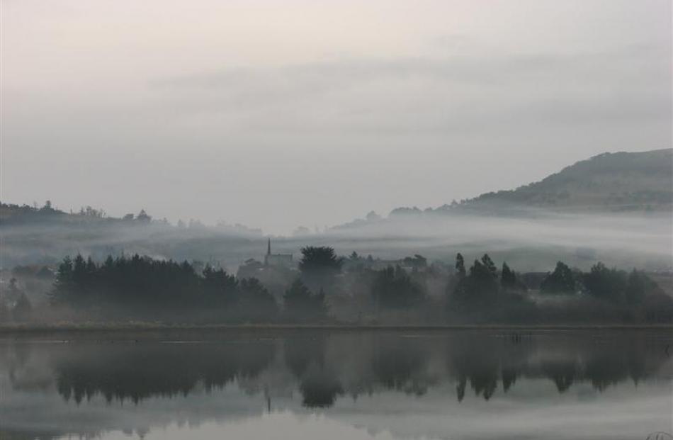 The still lagoon reflects the misty quiet hanging about the town of Waikouaiti.