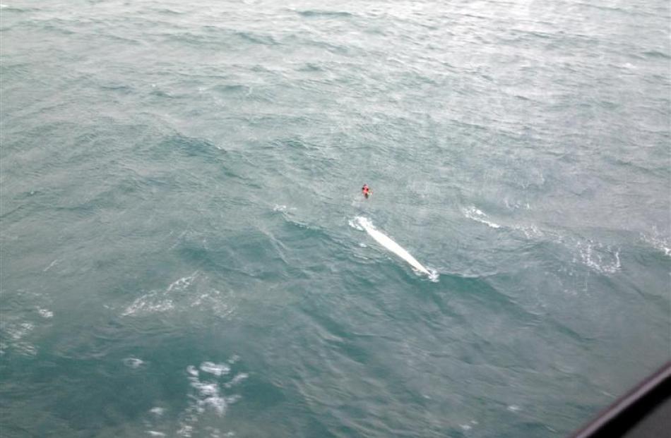 The swamped kayak drifts about 1km south of Taieri Island  yesterday.