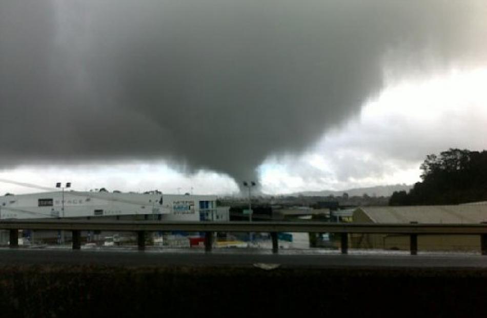 The tornado seen from State Highway 1, heading towards Albany on the North Shore. Photo by Chris...