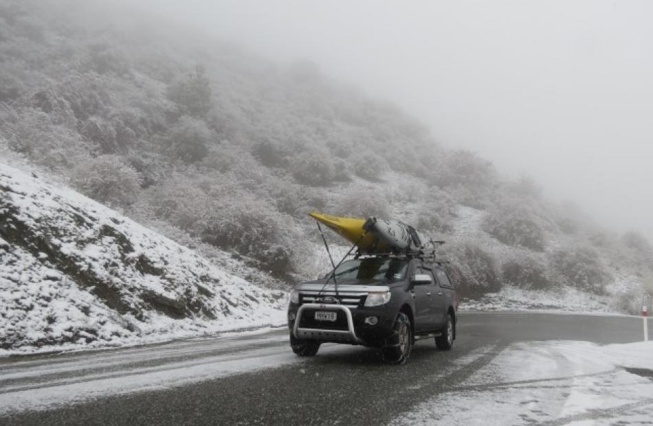 The use of chains allowed this kayak-carrying vehicle to tackle the Crown Range road between...