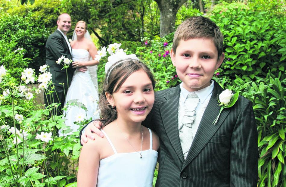 The young attendants, who are the bride's niece and nephew, at the wedding of Michaela...