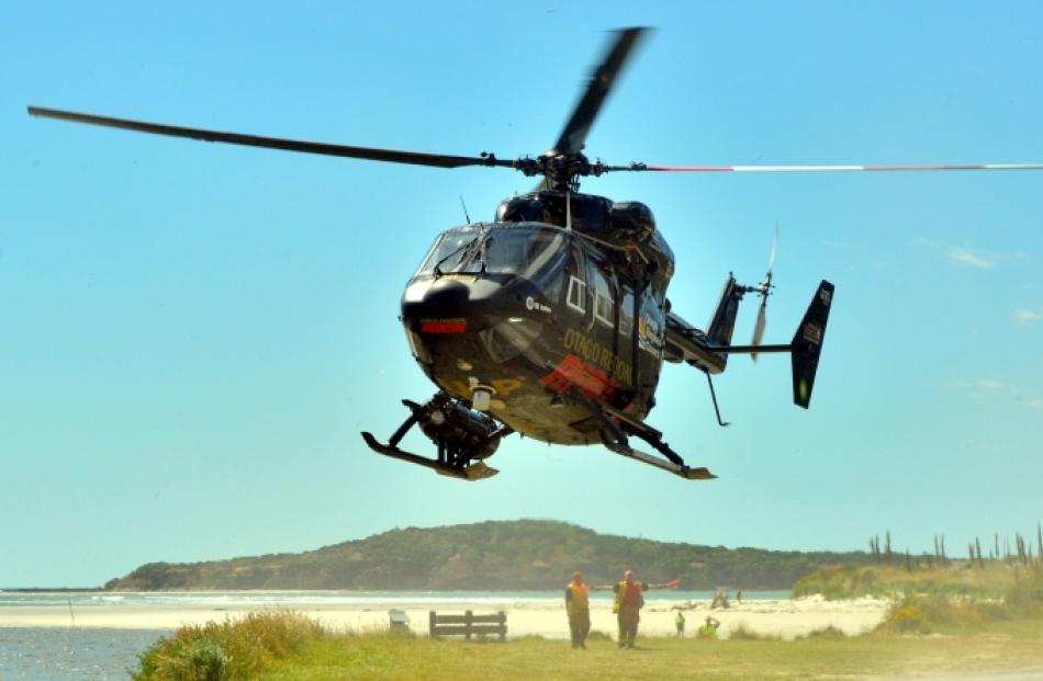 The Otago Regional Rescue Helicopter lands with two of the fishermen rescued near Taieri Mouth....