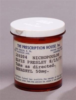 This image released by Julien's Auctions shows bottle for Benadryl 50mg prescribed to Elvis...