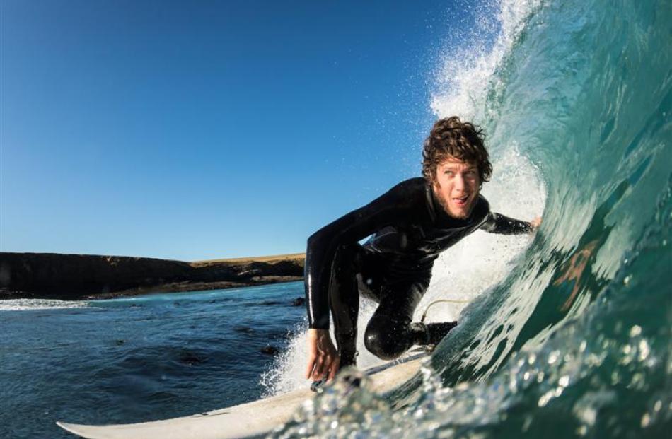 Thomas Forde, of Kaka Point, sweeps past Hayden Campbell while surfing the Catlins coast this...