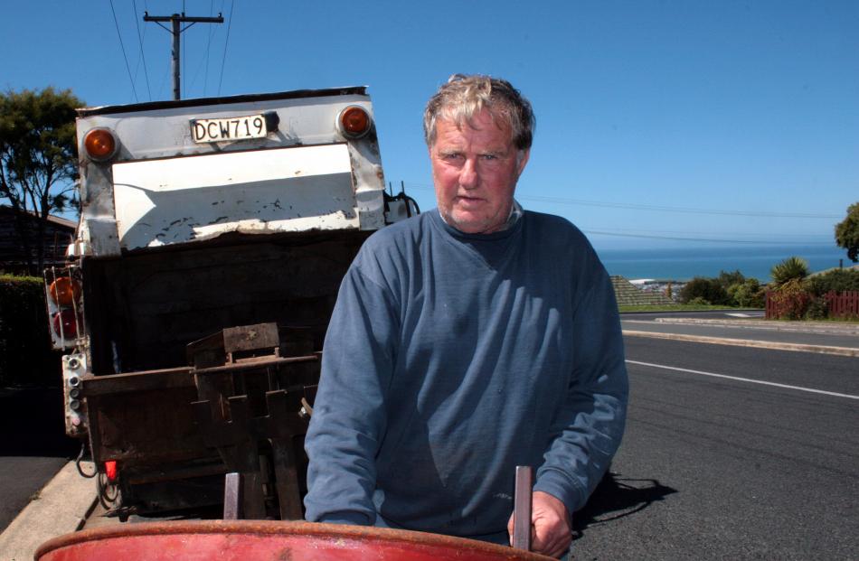 Tidy Bins owner Michael Miller rolls another drum out to his truck. After 15 years of handling...