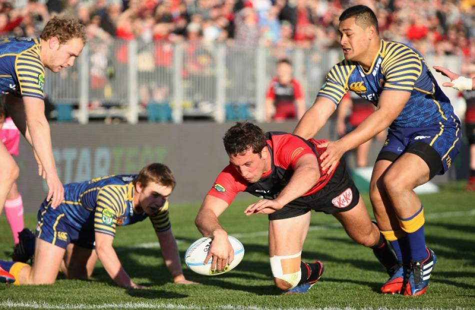 Tom Taylor of Canterbury scores a try in the tackle of Fa'aisu Fuatai of Otago during the round 5...