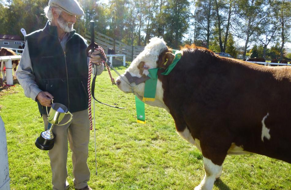 Tony Partridge, of Leeston, accepts the Lowry Austin Memorial Trophy for his Simmental bull,...