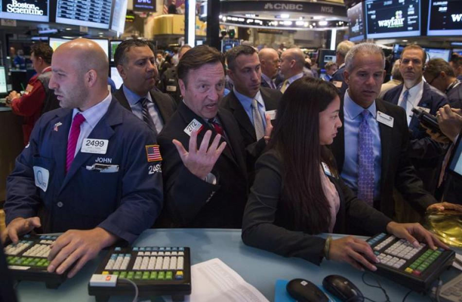 Traders at work on the floor of the New York Stock Exchange. Photo by Reuters.