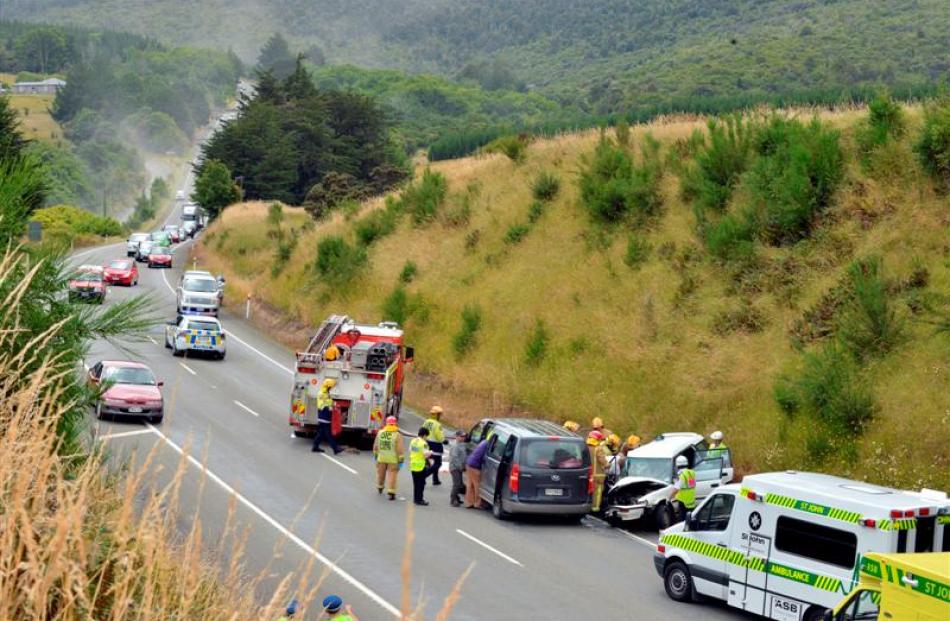 Traffic on Dunedin's Northern Motorway passes crashed vehicles in the southbound lane, while...