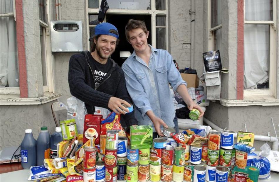 Trent Davis (left) and Michael Mitchell with items they have collected for Dunedin foodbanks....