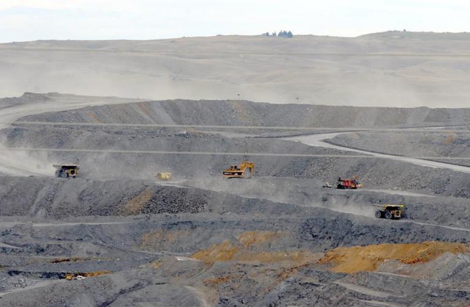 Trucks move ore at Oceana Gold's Macraes open pit in East Otago. Photo by Craig Baxter.