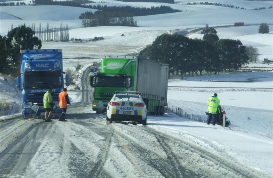Two trucks  stuck at the same point at Kaihiku Hill on State Highway 1 south of Balclutha...
