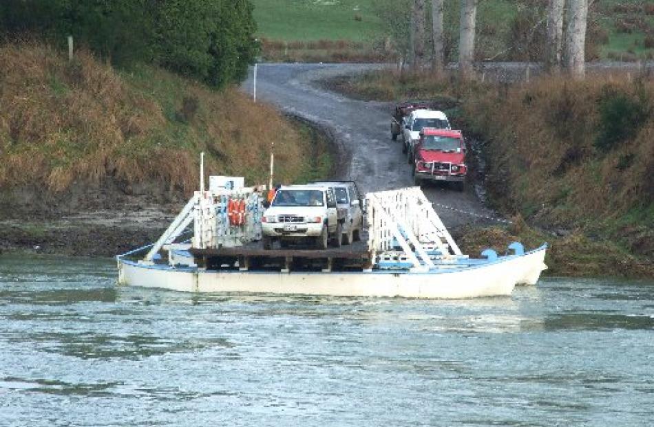Two utility vehicles are loaded on to the Tuapeka Mouth Ferry yesterday upstream from Clydevale....