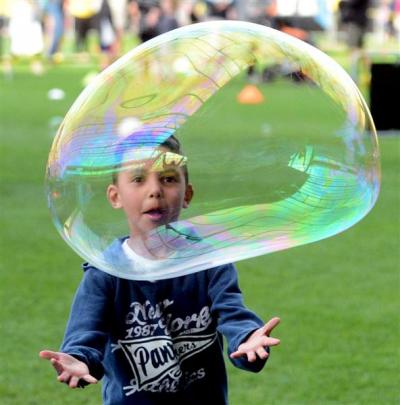 Tyler Malcolm (6) enjoys the giant bubbles at the Light Party.