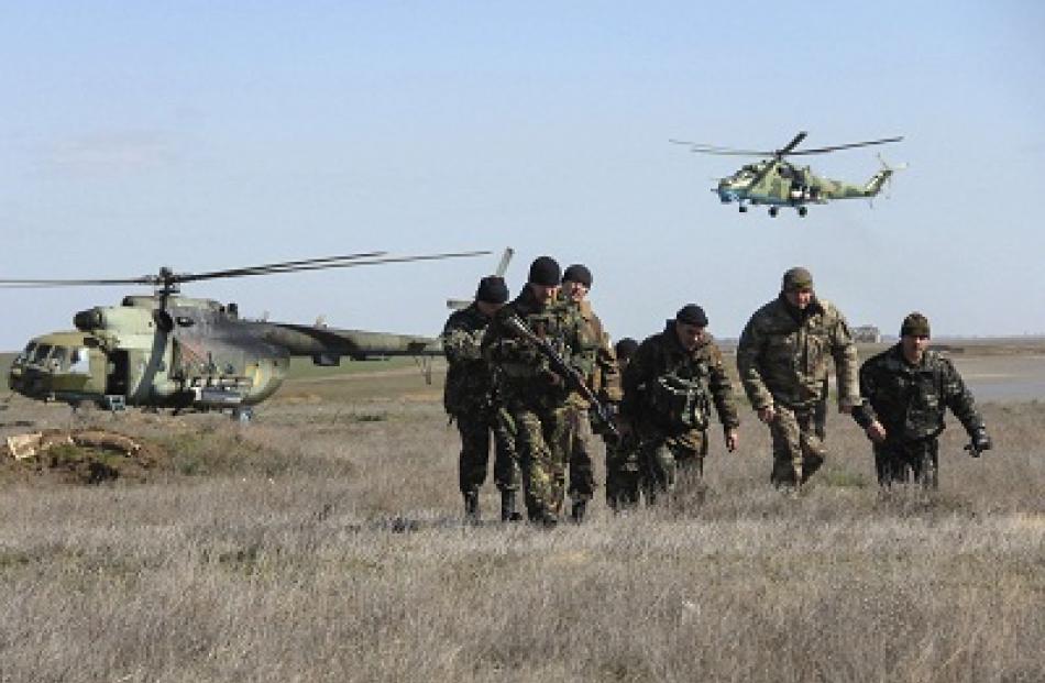 Ukrainian soldiers and military helicopters are seen near the village of Salkovo, in Kherson...