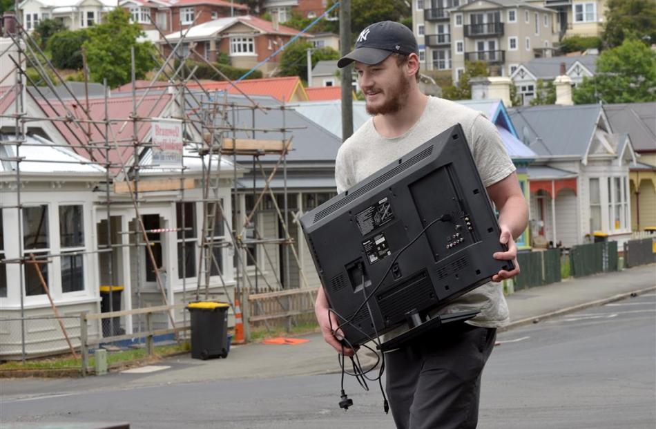 University of Otago commerce student Keegan Payne moves his belongings to another address...