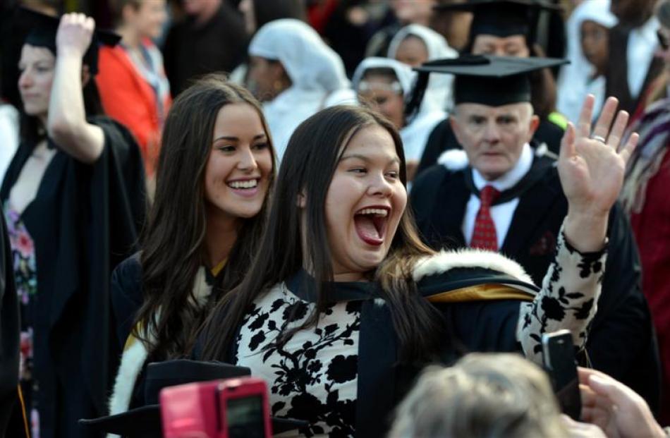 University of Otago graduand Cheyne Stevens (22) waves to friends during the  university...