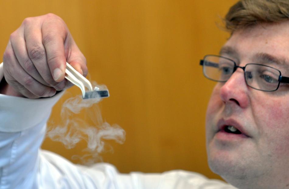 University of Otago physicist Associate Prof David Hutchinson with a small magnet hovering in mid...