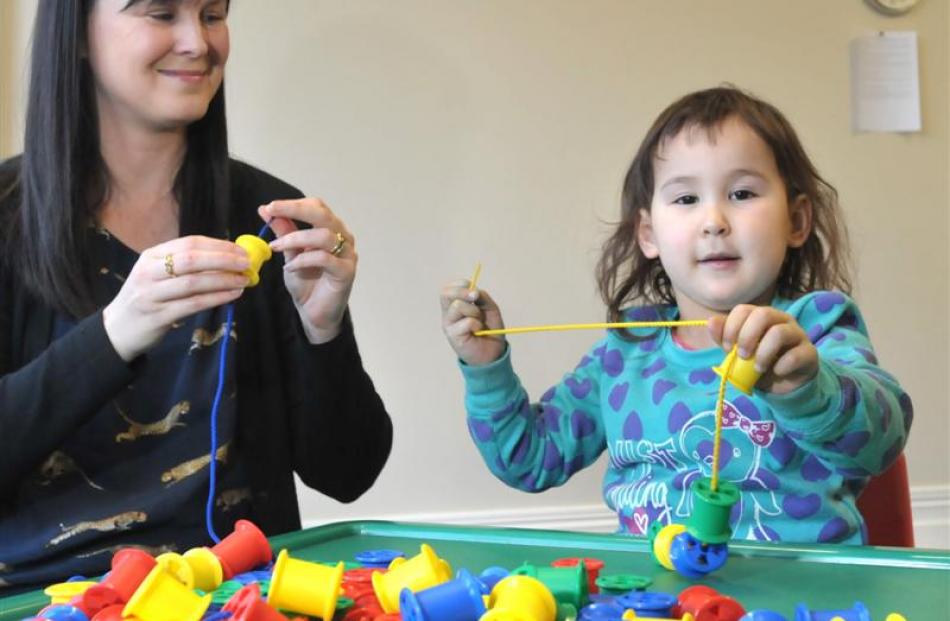 University of Otago psychology researcher Dr Dione Healey plays a game with Caydence Lane (3),...