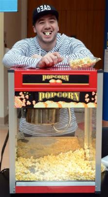 University of Otago student Geordi Dearns hands out popcorn during the Be Your Own Boss Expo in...