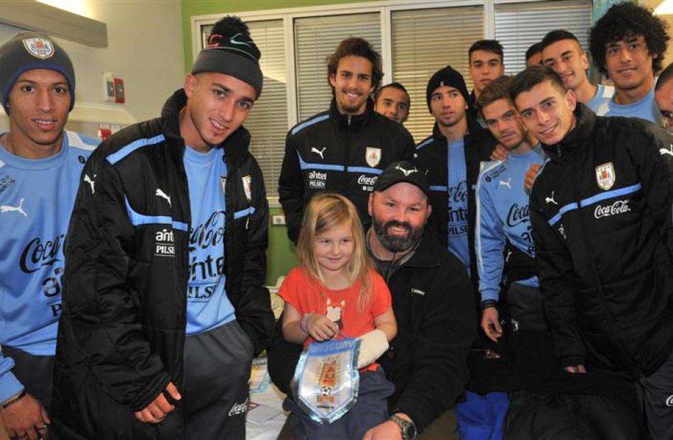 Uruguayan under-20 football players with (top) Ava Vercoe (5) and her father, former Otago rugby...