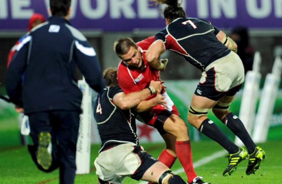 US captain Todd Clever (R) makes a late charge on Russia's Victor Gresev during their Rugby World...