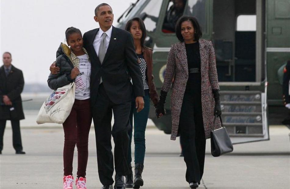 US President Barack Obama, First Lady Michelle Obama and their daughters,  Sasha (left) and Malia...