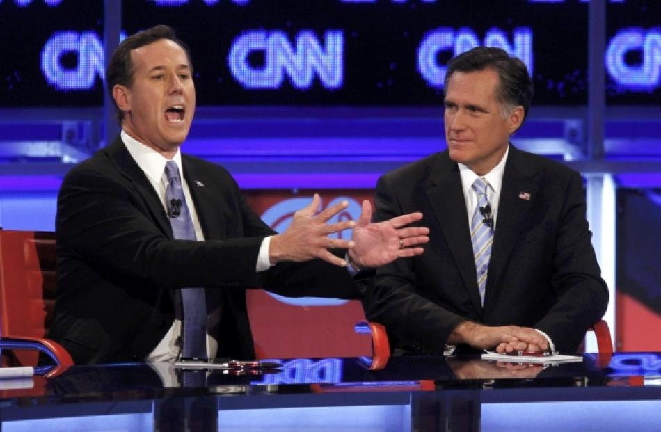 US Republican presidential candidate Rick Santorum speaks as former Massachusetts governor Mitt...