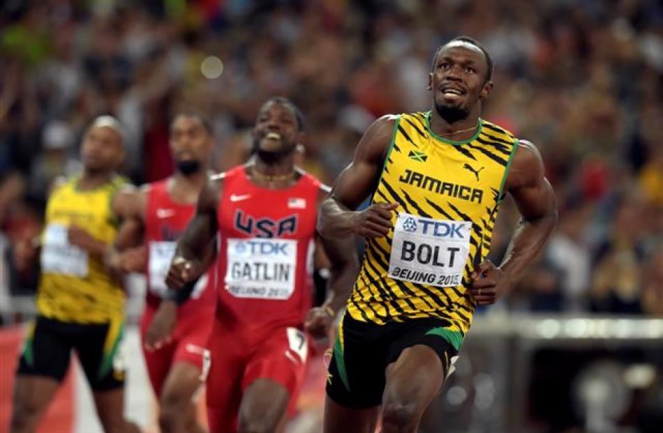 Usain Bolt won the 100m world title for a record-equalling third time in Beijing. Photo: Kirby...