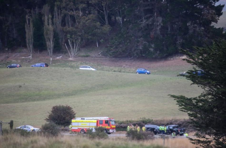 Vehicles (at top) take a detour while emergency services attend the scene of the crash yesterday....