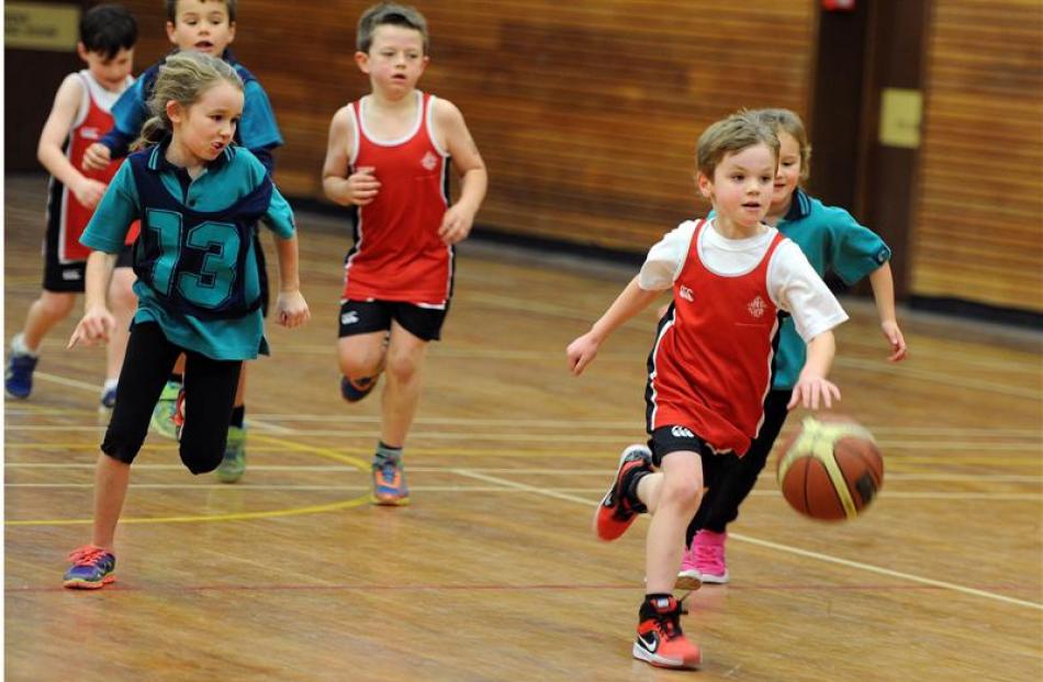 Victor Christoff (7), of  Fairfield School, leads the charge in the Taieri miniball competition...
