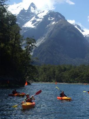 Visitors paddle back to the Discovery Centre, with Harrisons Valley and the Pembroke Glacier  in...