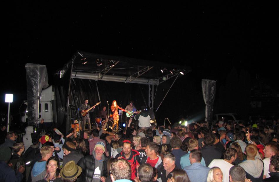 The crowd warms up at the Wanaka New Year's Eve concert on the lakeshore. Photo by Mark Price.
