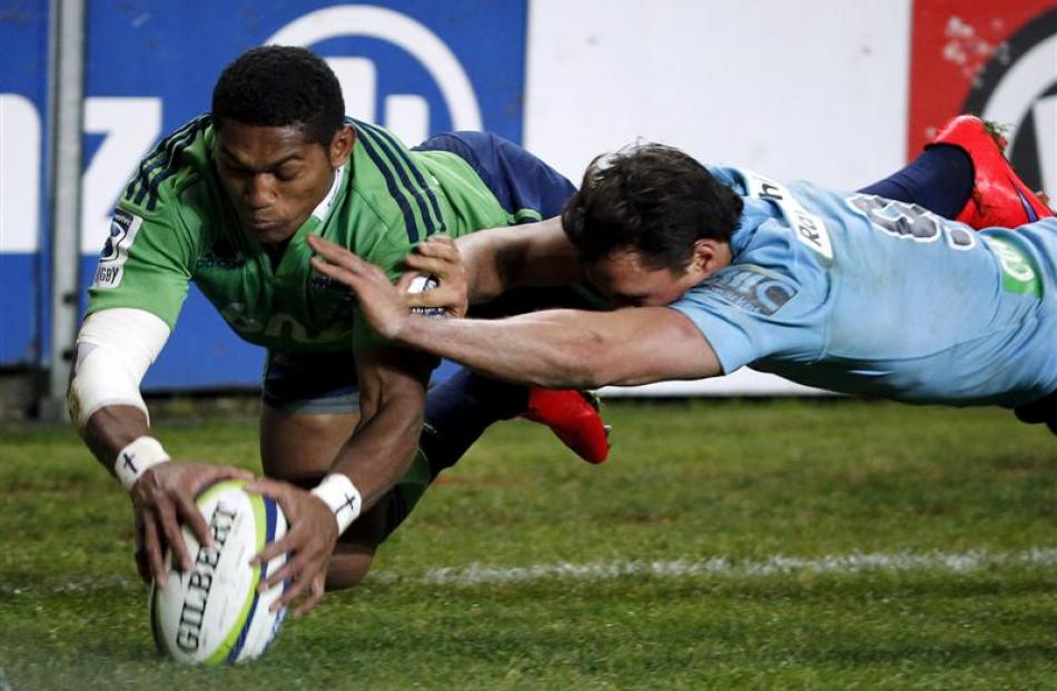Waisake Naholo dots down despite the attentions of Waratahs halfback Nick Phipps. Photos Reuters