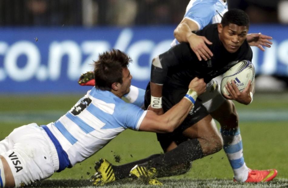 Waisake Naholo of the All Blacks is tackled by Argentina's Facundo Isa during their Rugby...