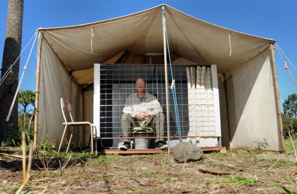 Waitati man Carl Scott in the cage  he  plans to stay in for a month to highlight the plight of...