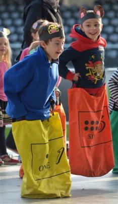 Wakari School pupils Jay Houston-Hynd (6) (left) and Takaia Green (6) jump in a sack race. Photos...