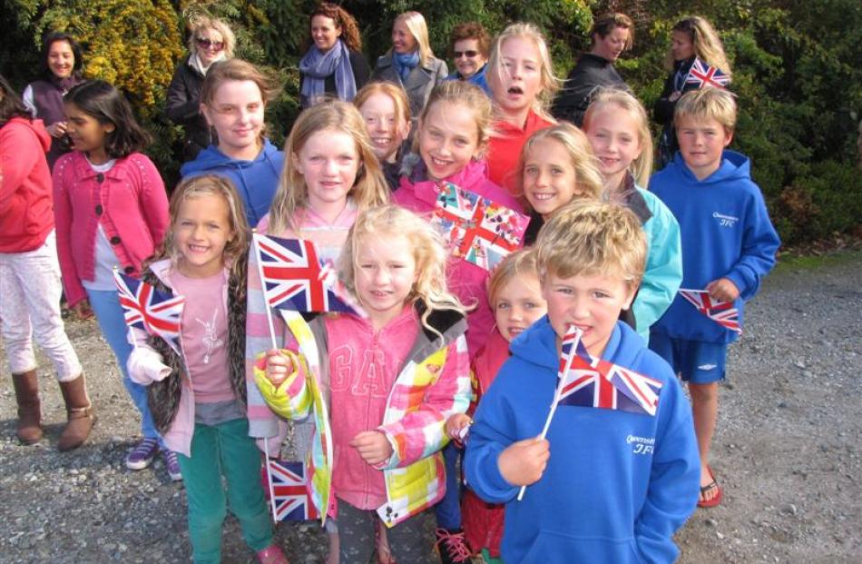 Wakatipu children wave their Union Jacks as they wait for the Duke and Duchess of Cambridge to...