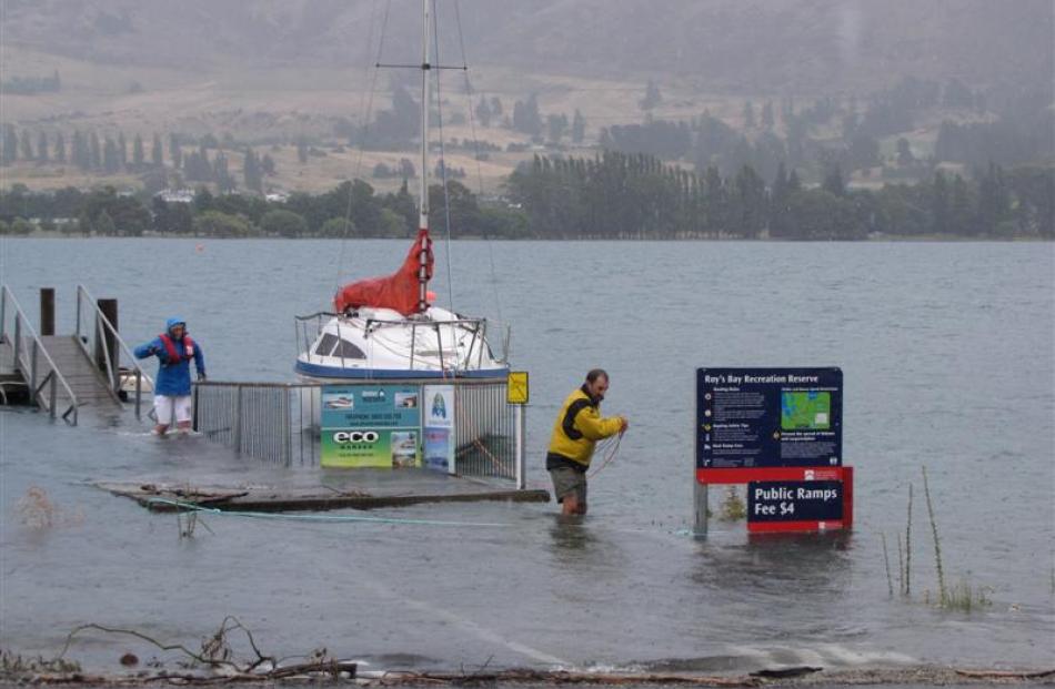 Wanaka holiday-makers Brett Gawn and his wife, Fay Paterson, both of Wellington, wade through the...
